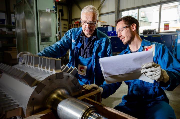 Two employees comparing plans to a product