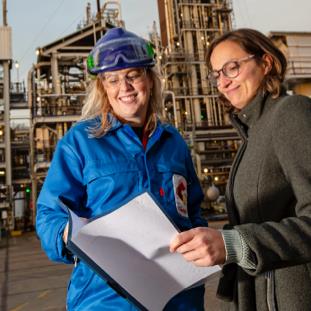 two employees reading a document