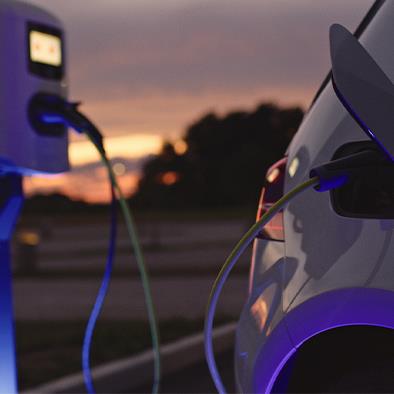 Electric vehicle plugged into charging station