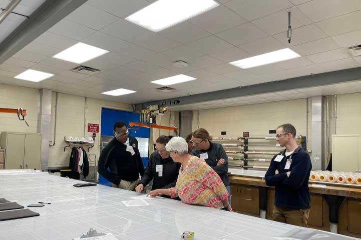 Students and teacher reviewing a document