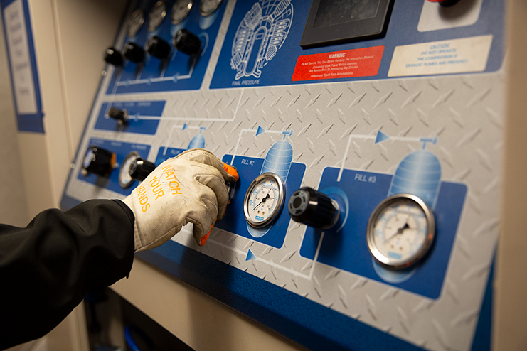 Employee turning dial on a machine