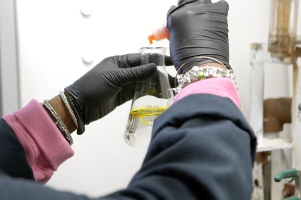 Employee filling beaker
