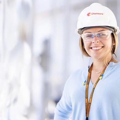 Woman wearing hardhats and safety glasses
