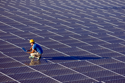 Man standing on a solar panel array