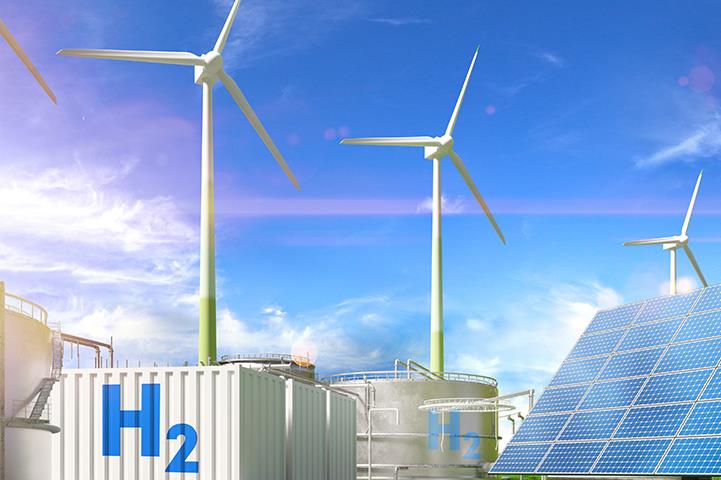 Windmills and solar panels under a blue sky