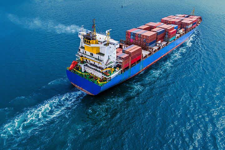 An image of a ship transporting containers of cargo in the open ocean.