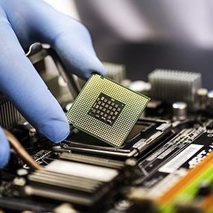 An image of a service technician installing an electronic component.