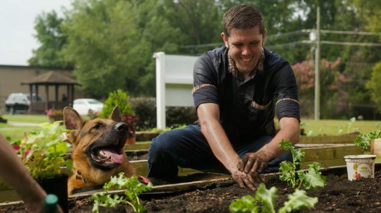 man and dog in a garden
