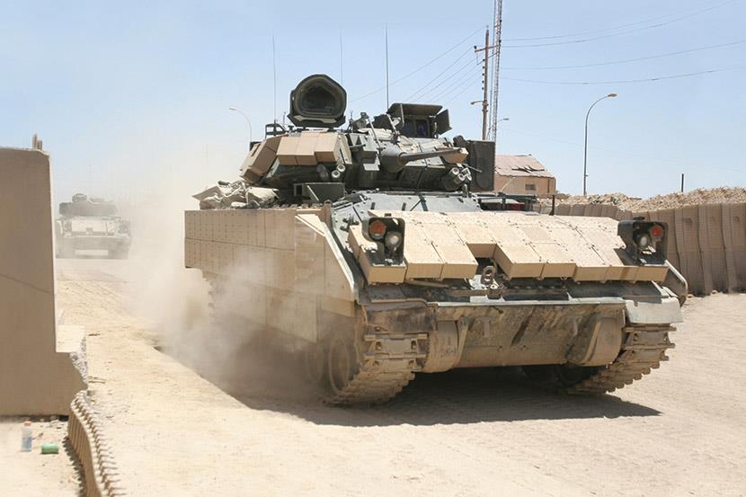 m2 bradley tank driving on dirt road
