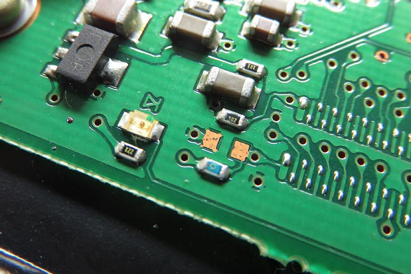 capacitors resistors connectors and diodes mounted on a printed circuit board