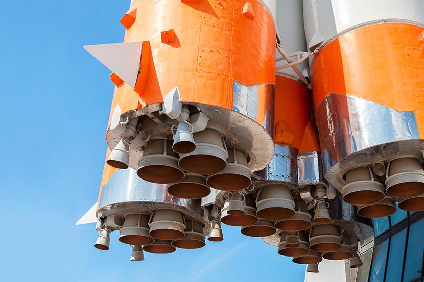 closeup bottom shot of orange and white space rocket engines 
