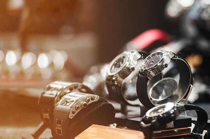 closeup of silver watches with black bands