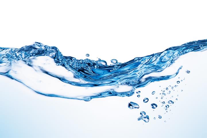 horizontal wave of water and a few bubbles on blue background