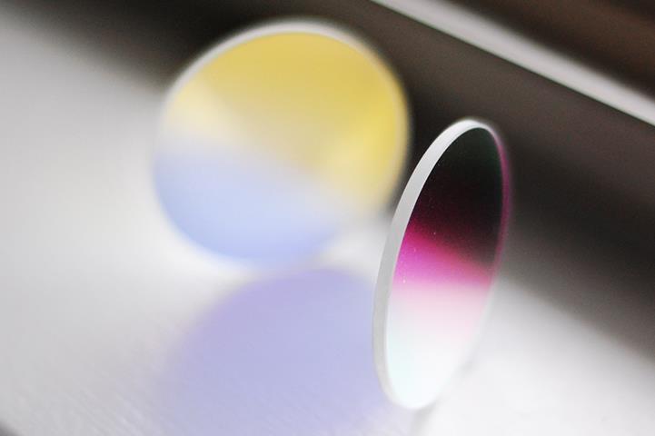 two round dichroic glass lenses