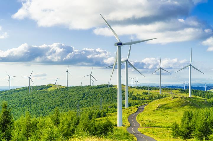 series of wind turbines in a field on a hill