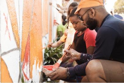 man and son painting a wall